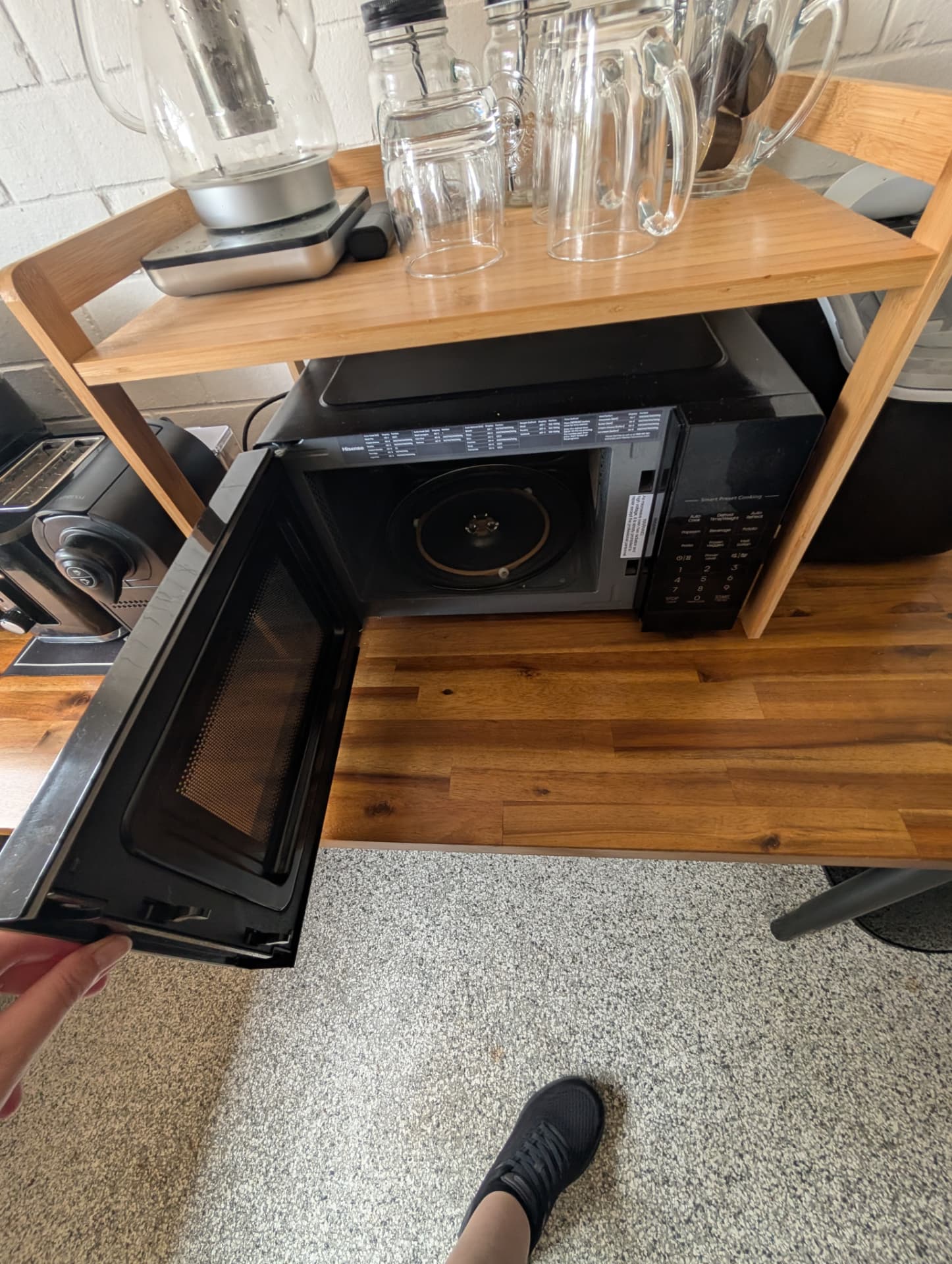 Microwave with the door open showing a clean interior and turntable