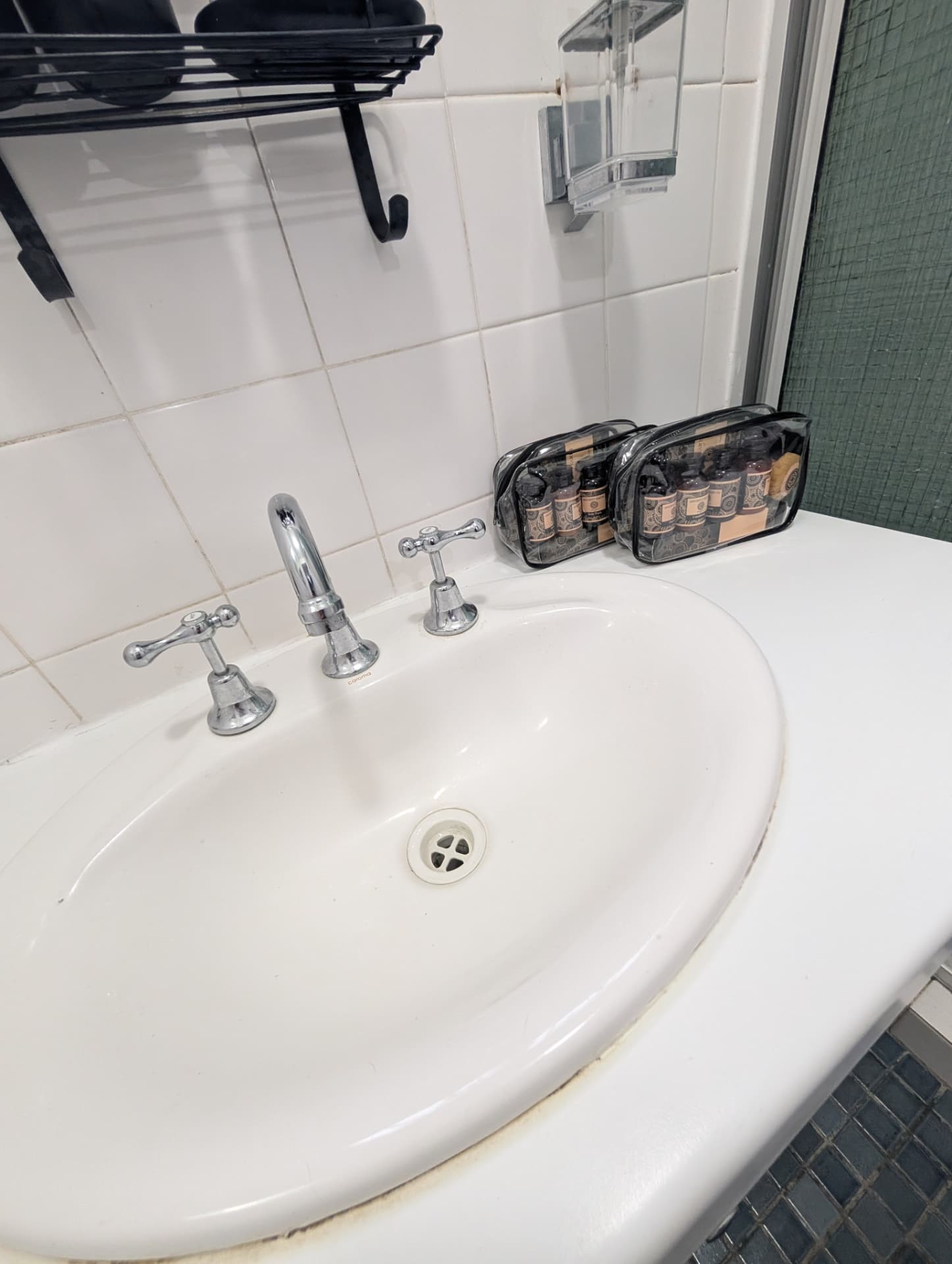 Bathroom vanity with toiletry packs laid out beside the basin