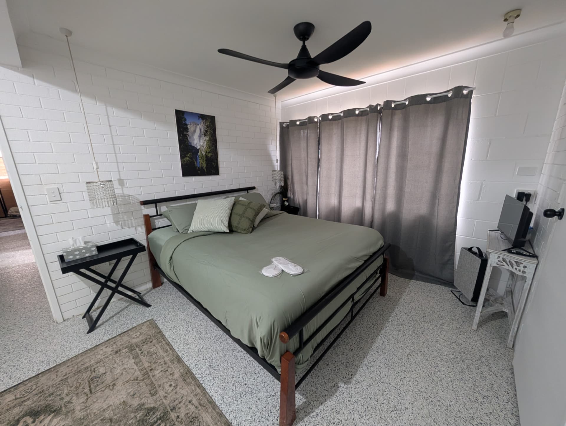 A rental bedroom cleaned and made up with fresh linen, ready for the next guest