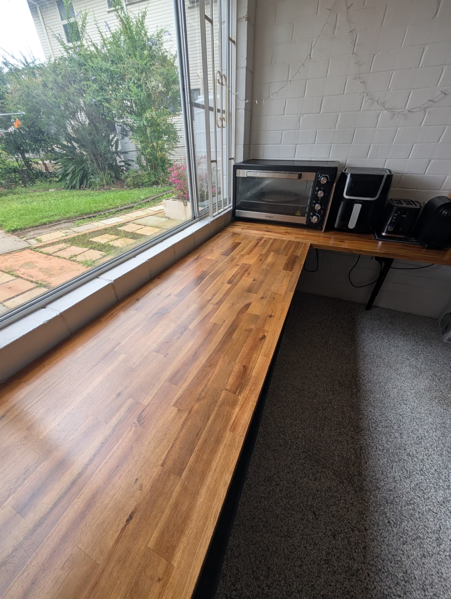 Cleared timber kitchen bench with oven, air fryer and toaster set out